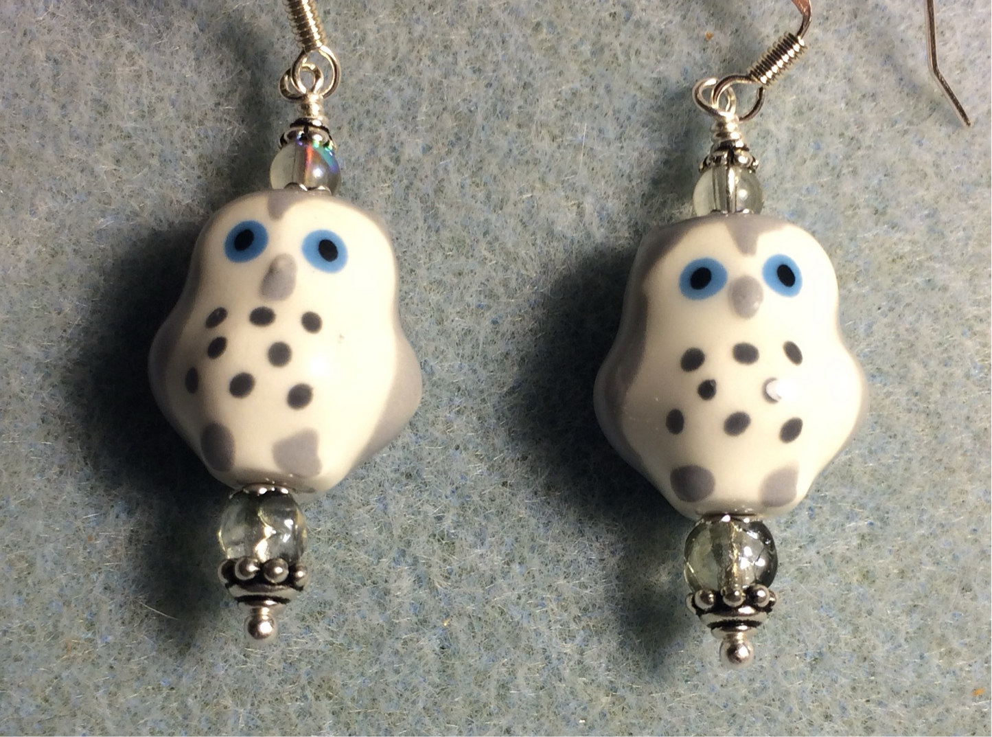 Gray, white, and blue ceramic spotted owl bead earrings adorned with clear Czech glass beads.