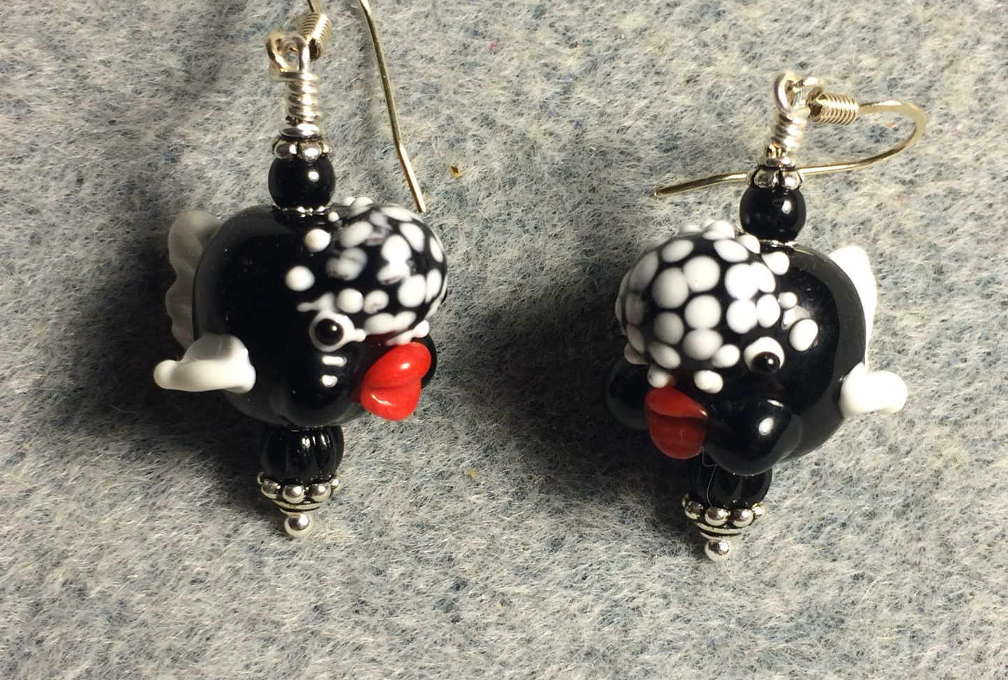 Opaque black and white lamp work clownfish bead earrings adorned with black Czech glass beads.