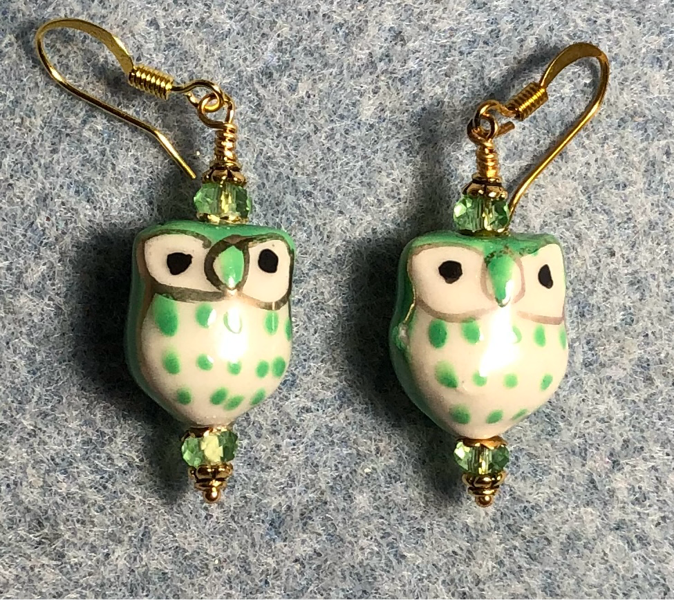 Green and white ceramic spotted owl bead earrings adorned with green Chinese crystal beads.