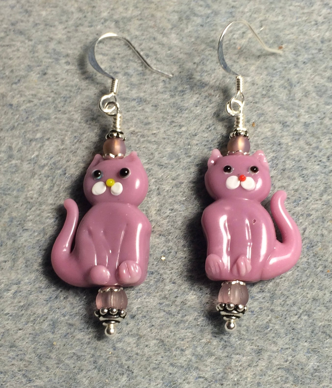 Opaque mauve pink lamp work cat bead earrings adorned with pink Czech glass beads.