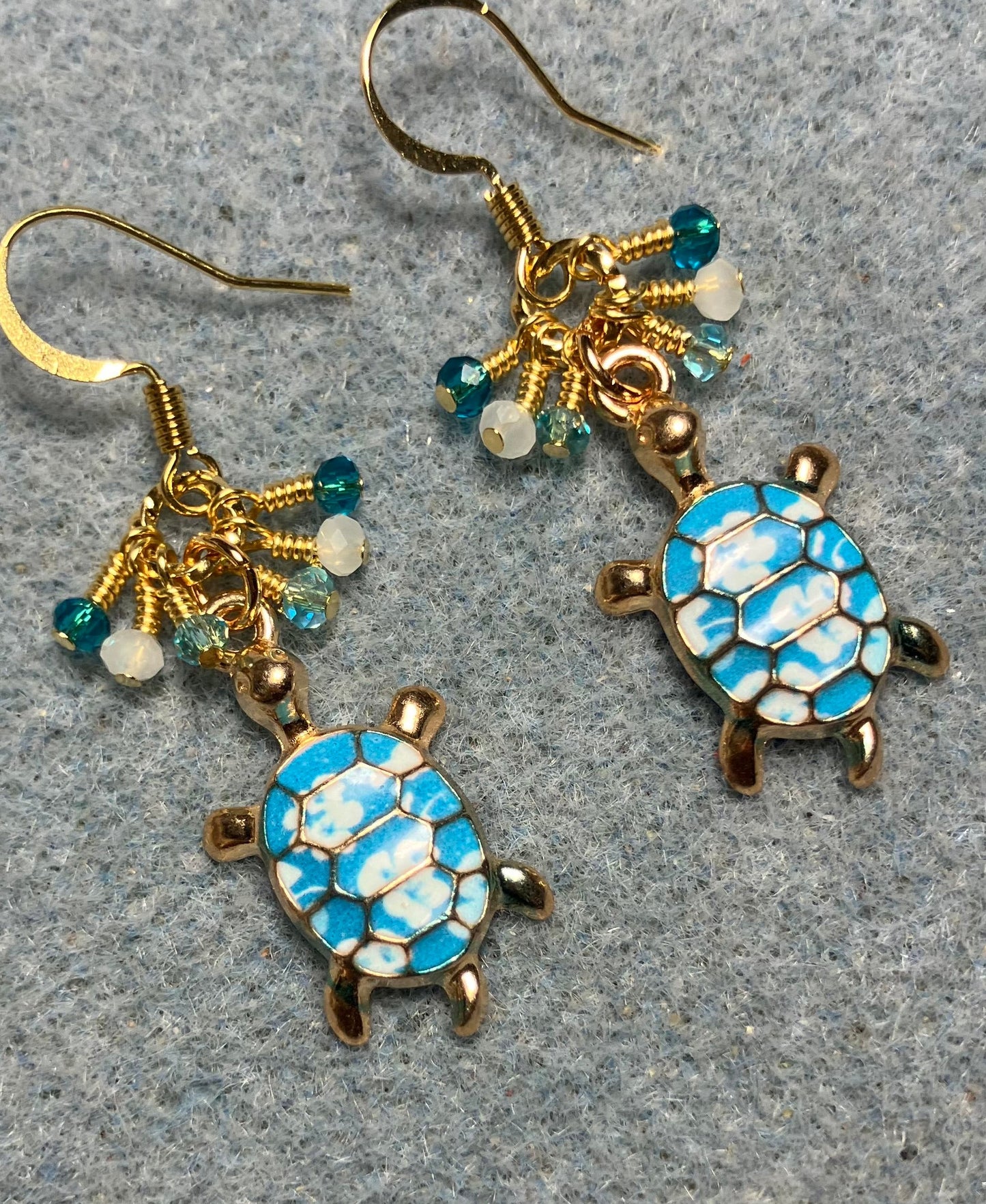 Turquoise and white enamel turtle charm earrings adorned with tiny dangling turquoise and white Chinese crystal beads.