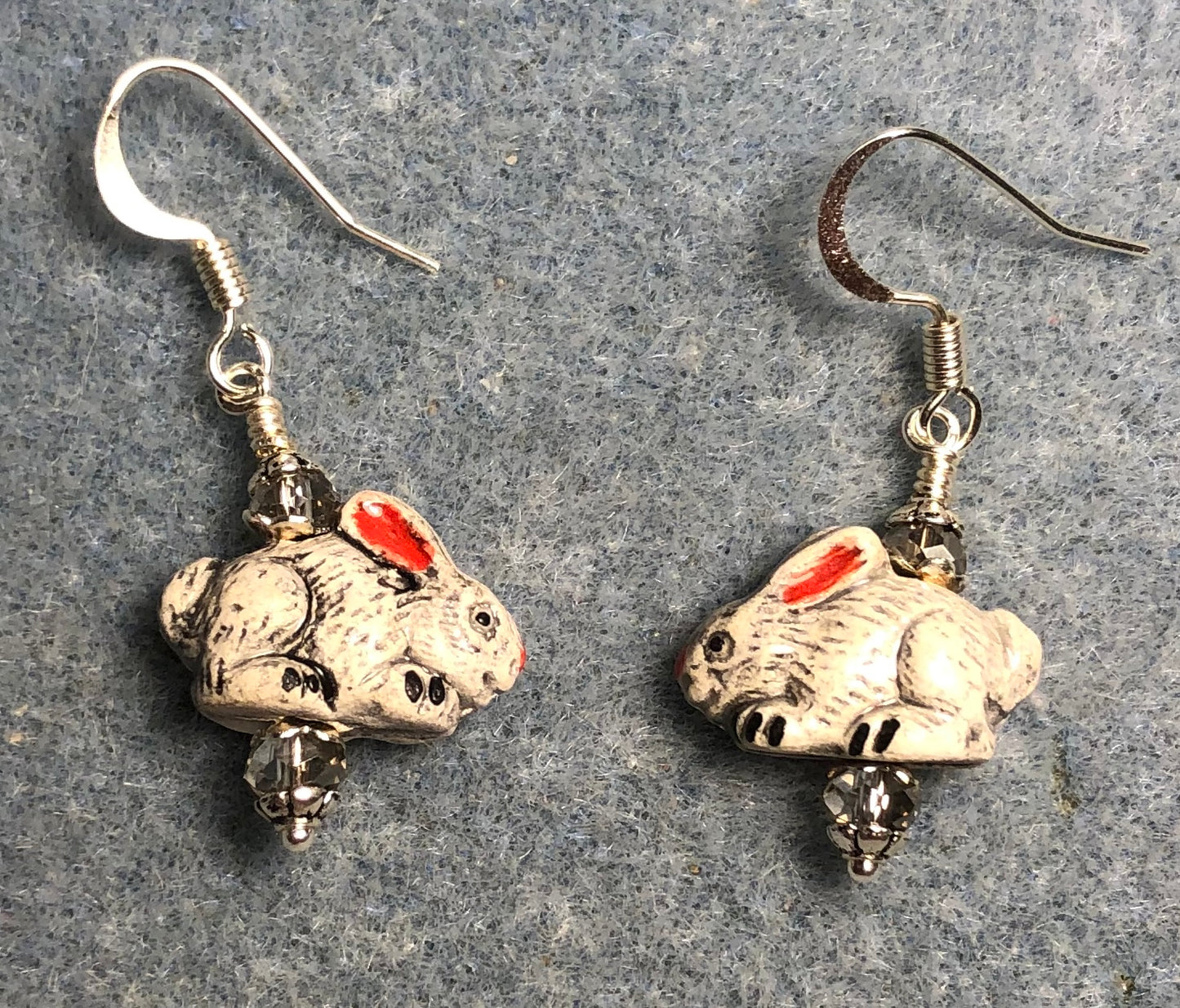 Small gray and pinkish red ceramic rabbit bead earrings adorned with gray Chinese crystal beads.