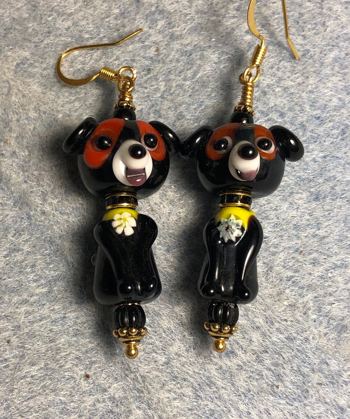 Black, brown, and yellow lamp work puppy dog bead earrings adorned with black rhinestone rondelle “collars” and black Czech glass beads.