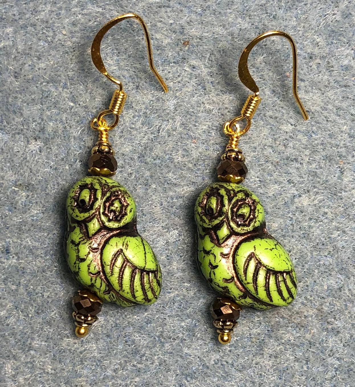 Green (with brown wash) fancy Czech glass owl bead earrings adorned with brown Chinese crystal beads.