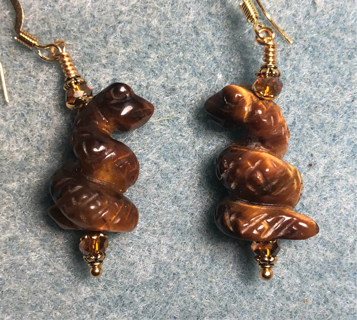 Tigereye gemstone coiled snake bead earrings adorned with amber Chinese crystal beads.
