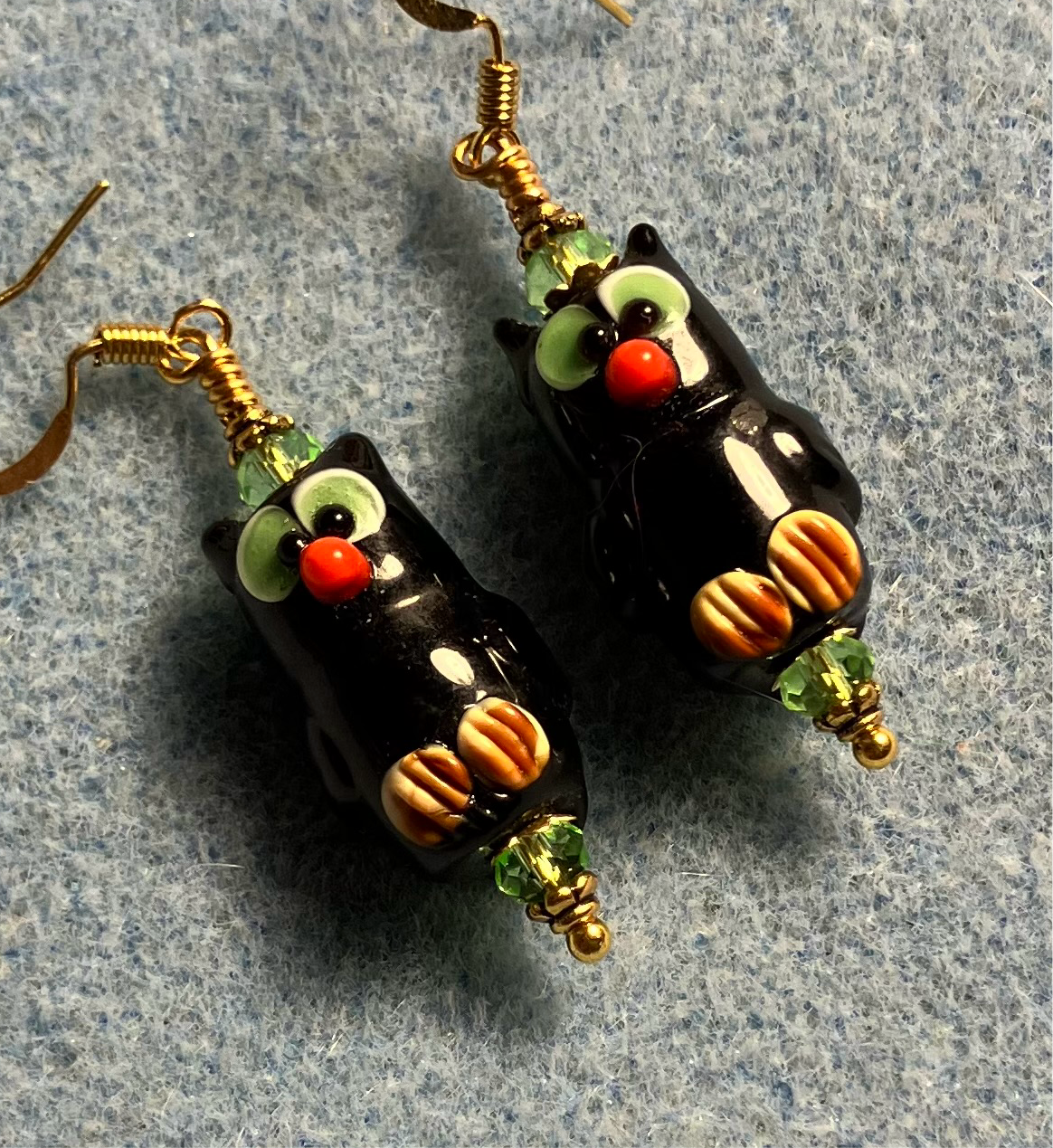 Black and green lamp work owl bead earrings adorned with green Chinese crystal beads.