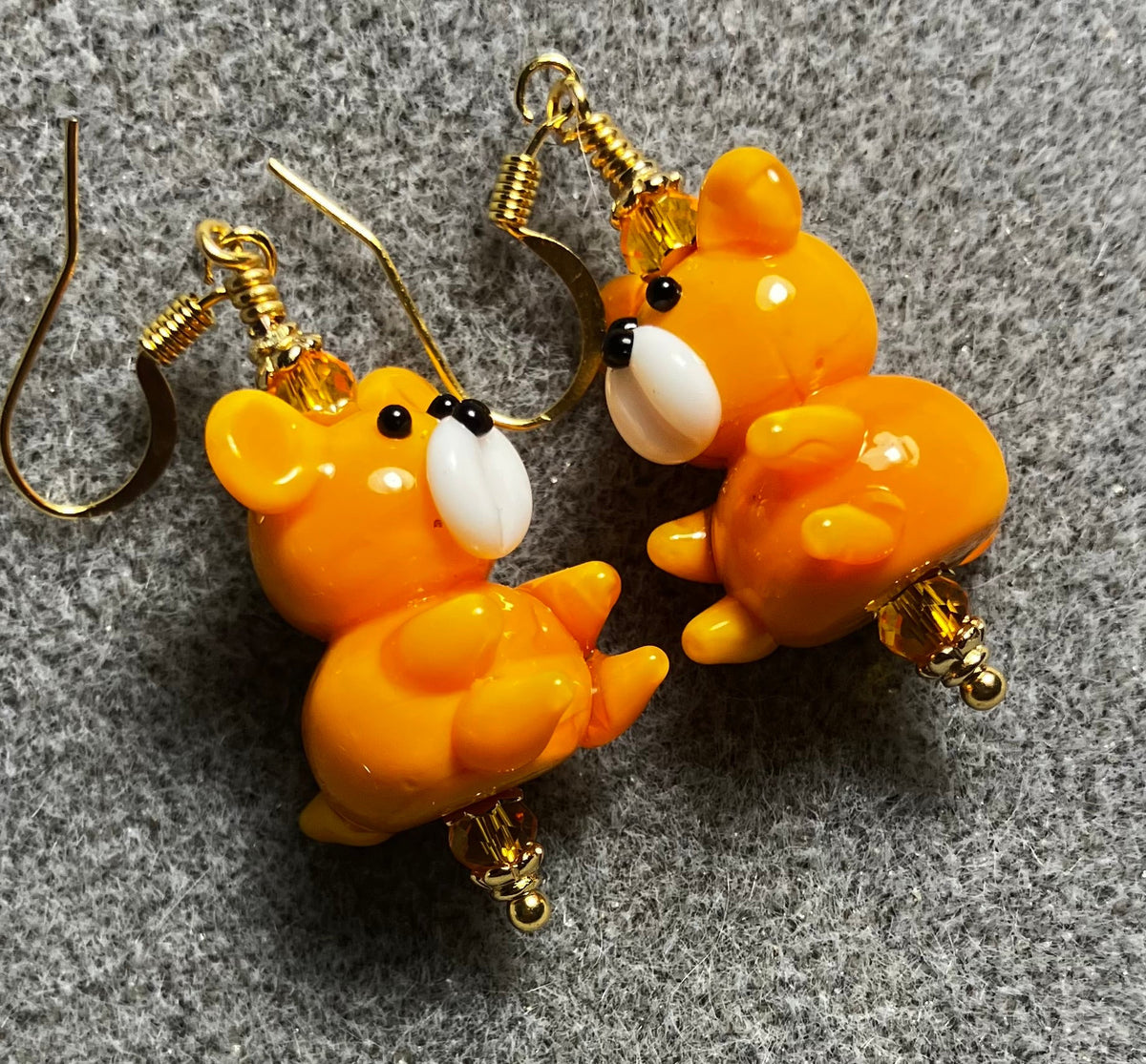 Tangerine and white lamp work teddy bear bead earrings adorned with tangerine Chinese crystal beads.