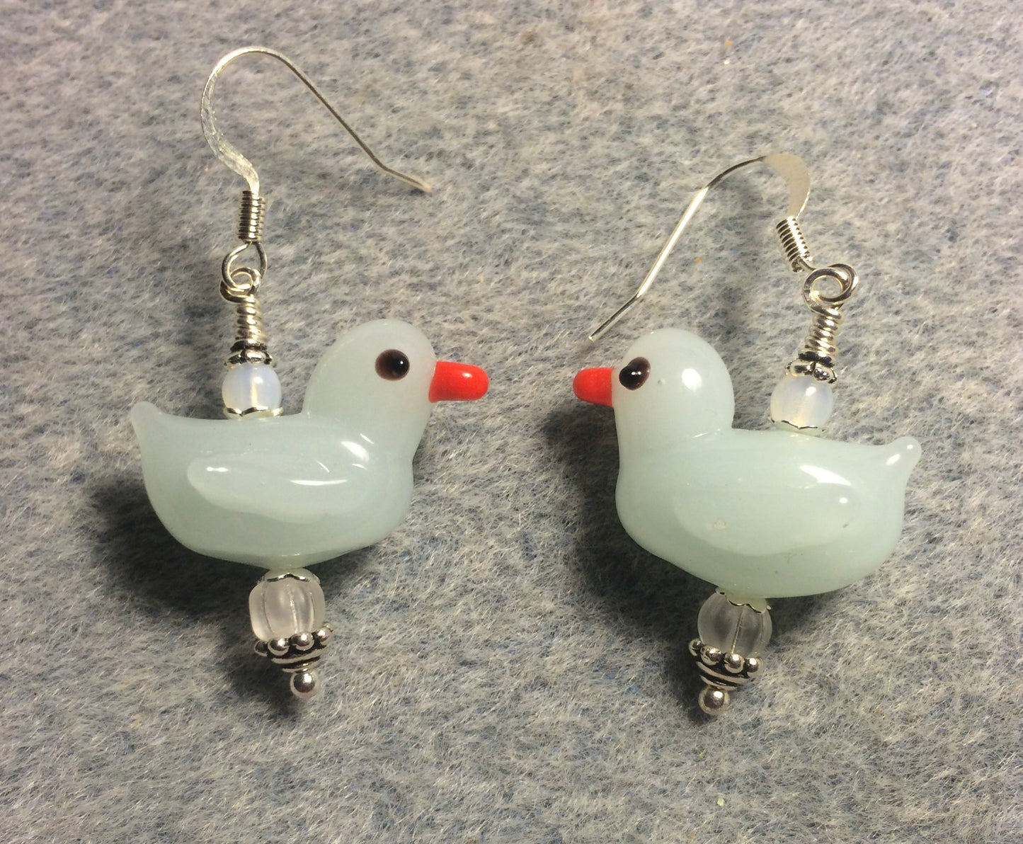 Opaque white lamp work duck bead earrings adorned with clear Czech glass beads.