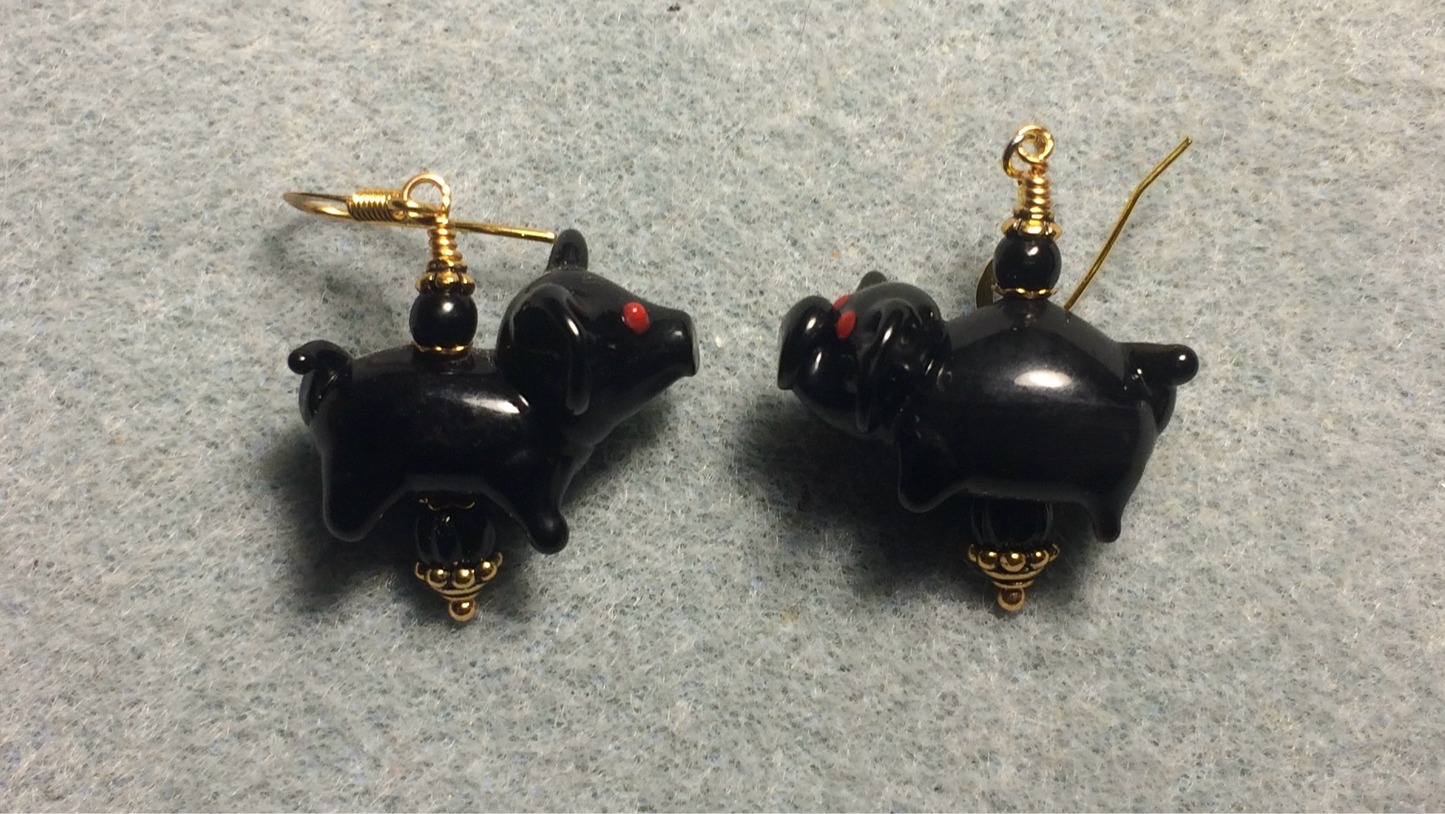 Opaque black lamp work pig bead earrings adorned with black Czech glass beads.