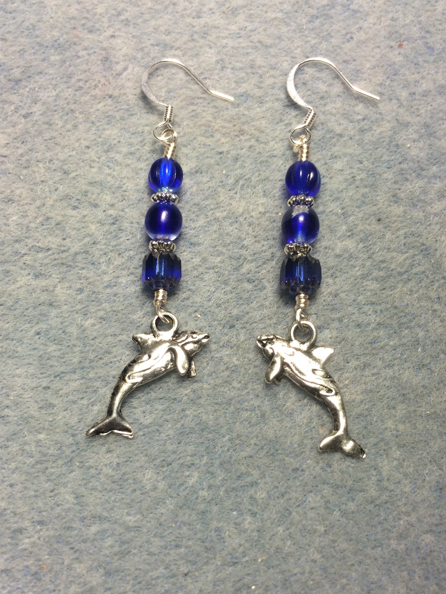 Silver whale charm earrings adorned with dark blue Czech glass beads