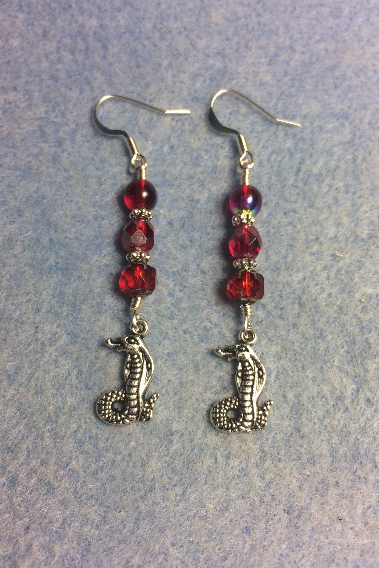 Silver cobra charm earrings adorned with red Czech glass beads