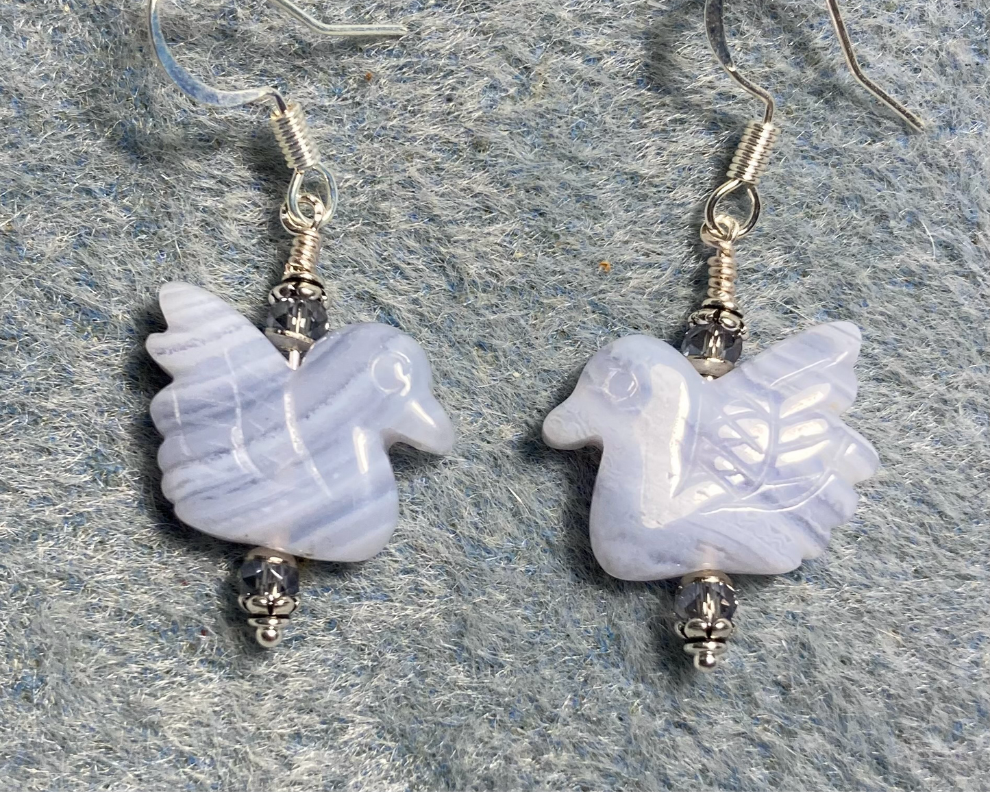 Gorgeous blue lace agate gemstone duck bead earrings adorned with light blue Chinese crystal beads.