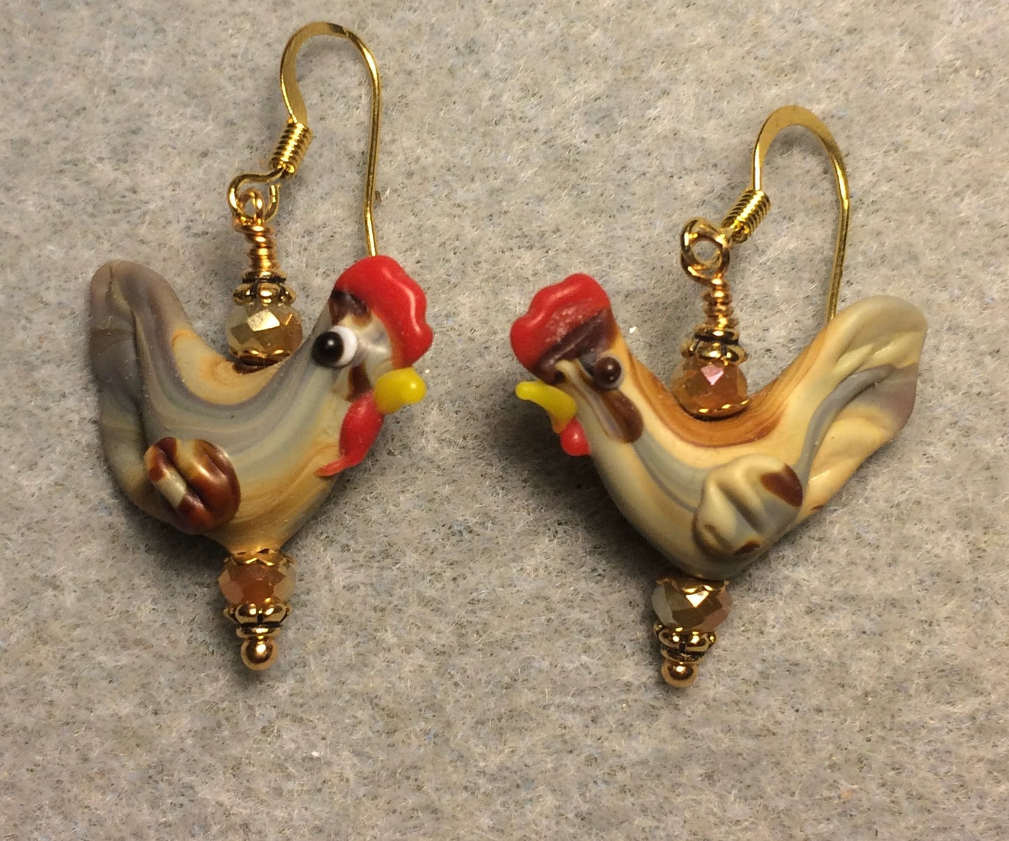 Tan lamp work chicken bead earrings adorned with tan Chinese crystal beads.