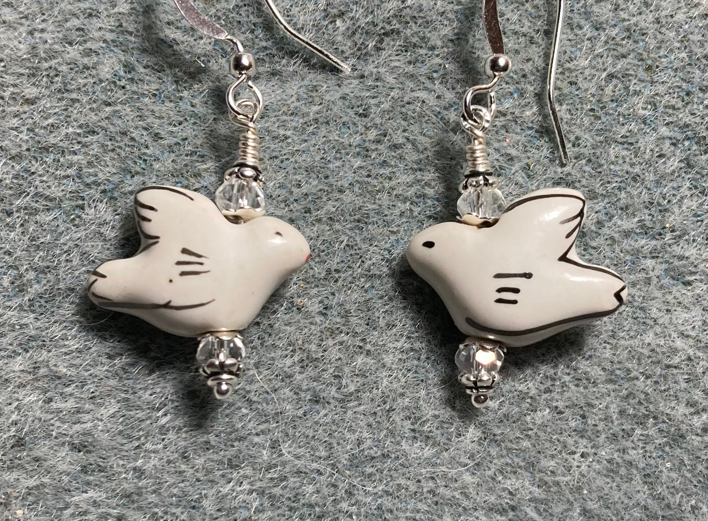 White ceramic dove bead earrings adorned with clear Chinese crystal beads.