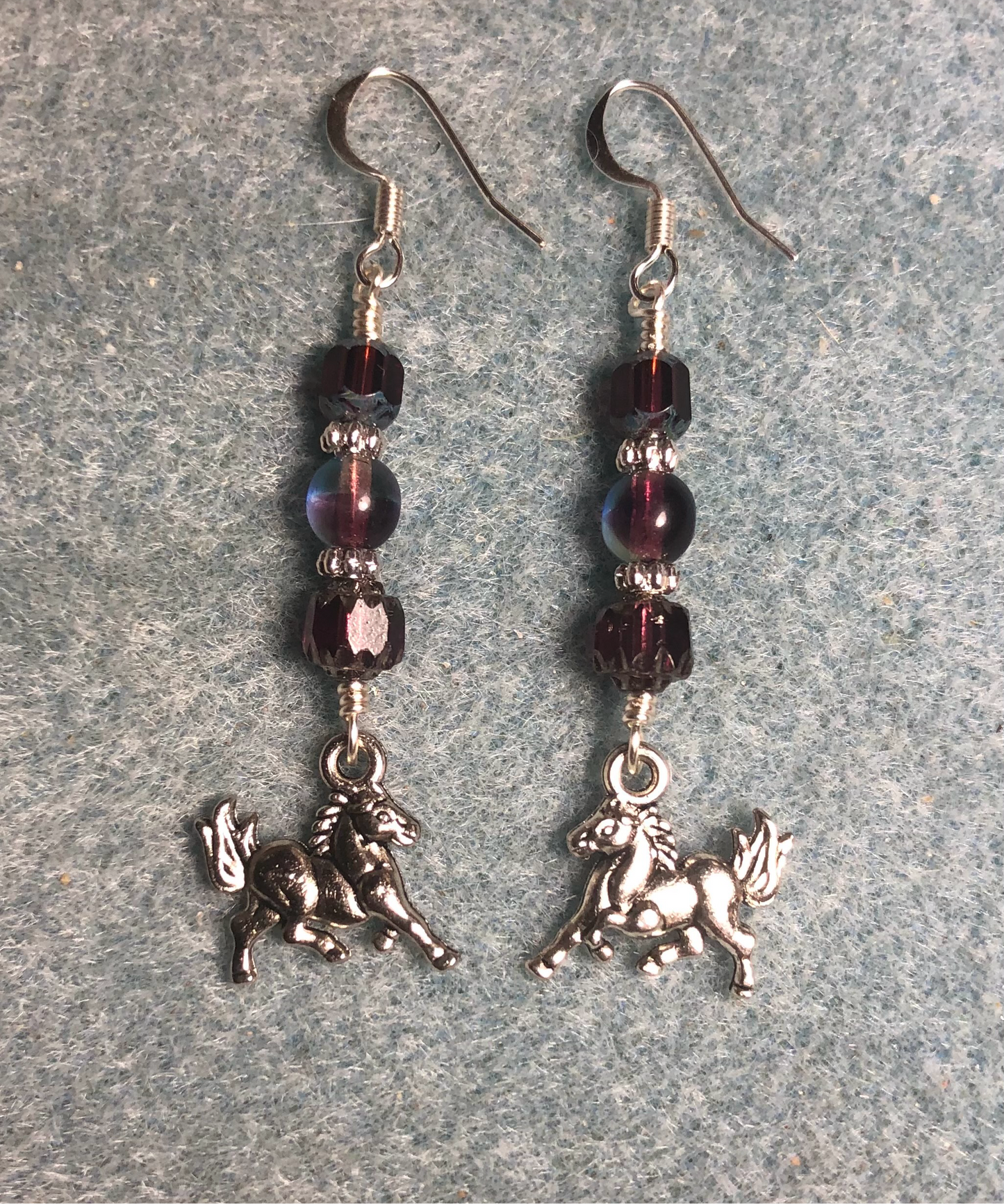 Silver horse charm earrings adorned with purple Czech glass beads