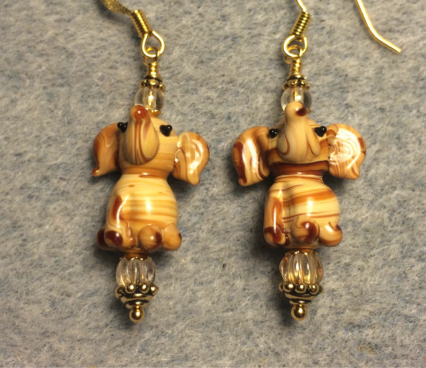 Tan striped lamp work sitting elephant bead earrings adorned with amber Czech glass beads.