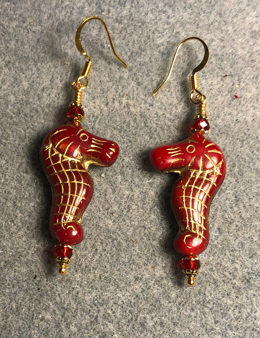 Dark red (with gold inlay) Czech glass seahorse bead earrings adorned with dark red Chinese crystal beads.