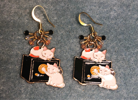 White, black, and orange enamel cat charm earrings adorned with tiny dangling white, black, and orange Chinese crystal beads.