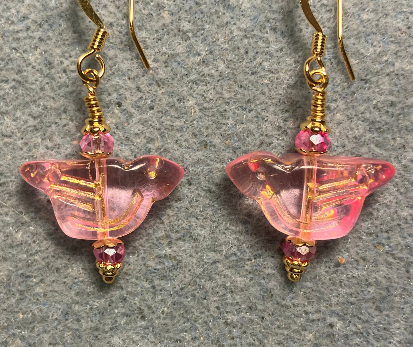 Translucent pink (with gold wash) Czech glass bird bead earrings adorned with pink Chinese crystal beads.