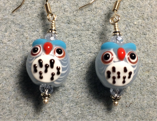Light blue and white lamp work spotted owl bead earrings adorned with light blue Chinese crystal beads.