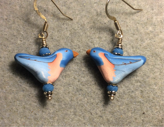Blue and peach polymer clay bird bead earrings adorned with blue Chinese crystal beads.