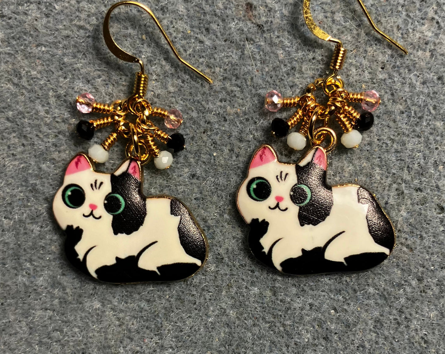 Black, white, and pink enamel cat charm earrings adorned with tiny dangling black, white, and pink Chinese crystal beads.