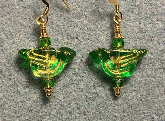 Translucent green (with gold wash) Czech glass bird bead earrings adorned with green Chinese crystal beads.