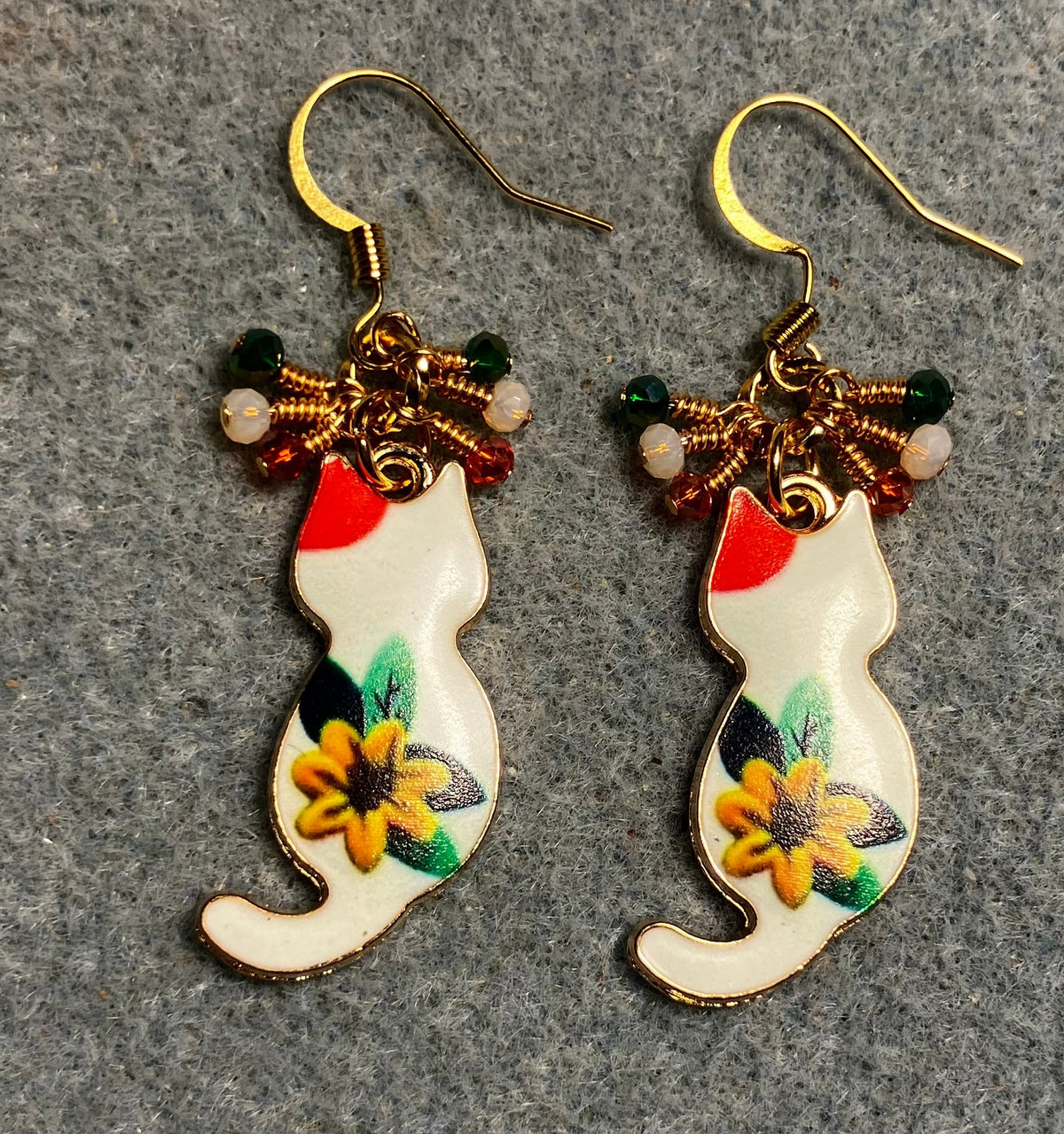 White, orange, amber, and green enamel cat charm earrings adorned with tiny dangling white, orange, and green Chinese crystal beads.