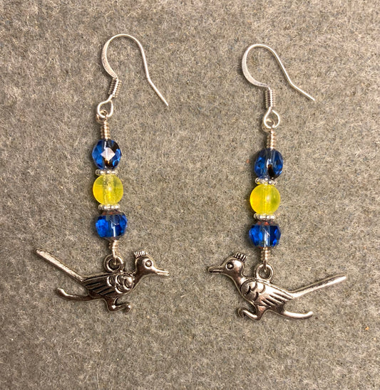 Silver roadrunner charm earrings adorned with blue and yellow Czech glass beads.