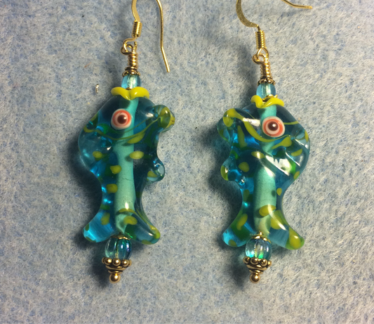 Turquoise and yellow lamp work fish bead earrings adorned with turquoise Czech glass beads.