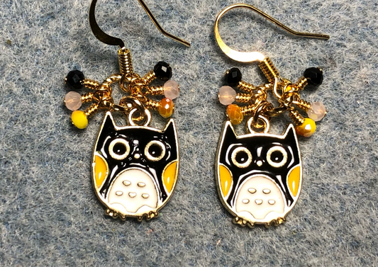 Black, yellow, and white enamel owl charm earrings adorned with tiny dangling black, yellow, and white Chinese crystal beads.