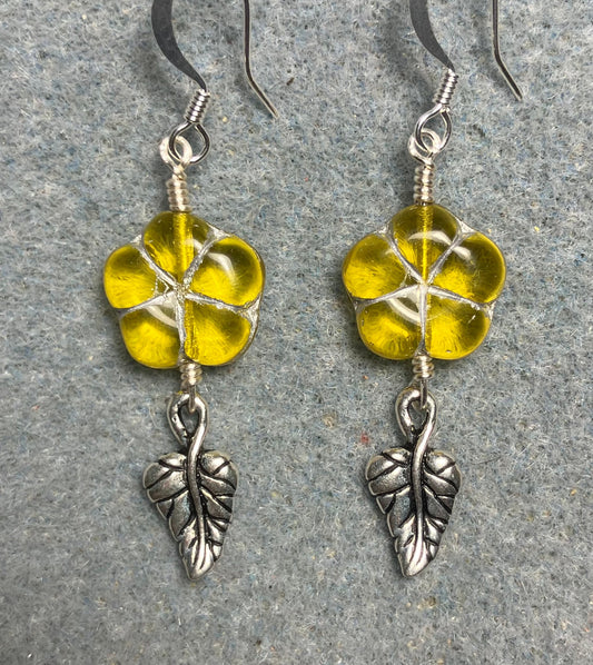 Yellow (with silver inlay) Czech glass puffy flower bead earrings adorned with silver Tierracast leaf charms.