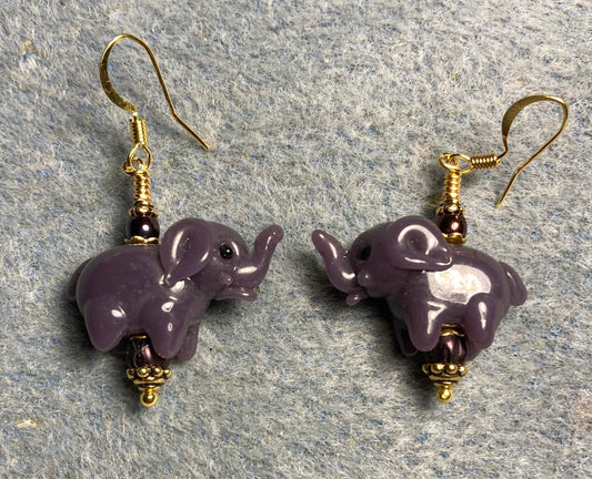 Opaque dark purple lamp work elephant bead earrings adorned with dark purple Czech glass beads.