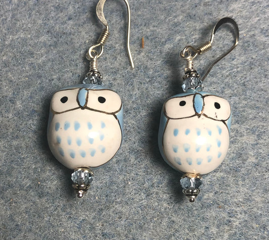 Light blue and white ceramic spotted owl bead earrings adorned with light blue Chinese crystal beads.