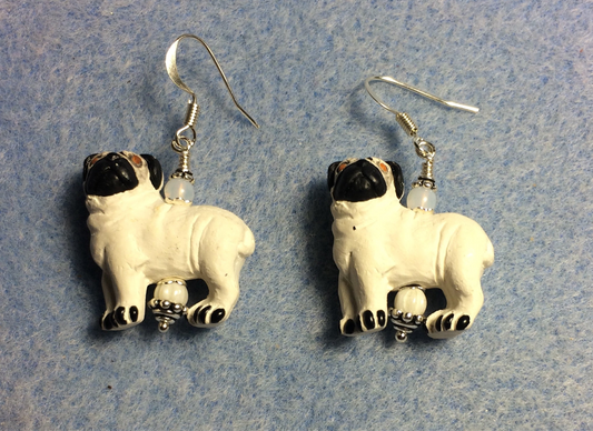 White and black ceramic pug bead earrings adorned with white Czech glass beads.