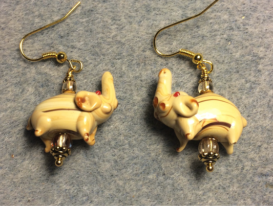 Tan and brown lamp work striped elephant bead earrings adorned with tan Czech glass beads.