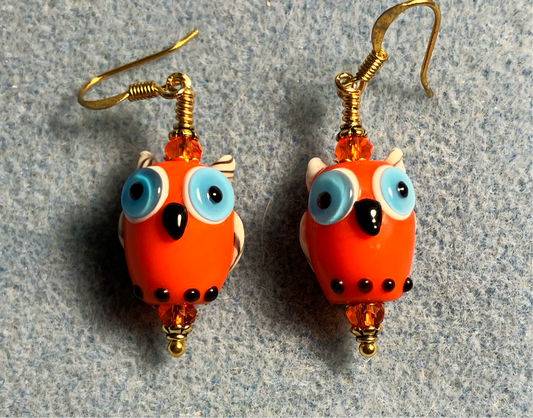 Orange lamp work owl bead earrings adorned with orange Chinese crystal beads.