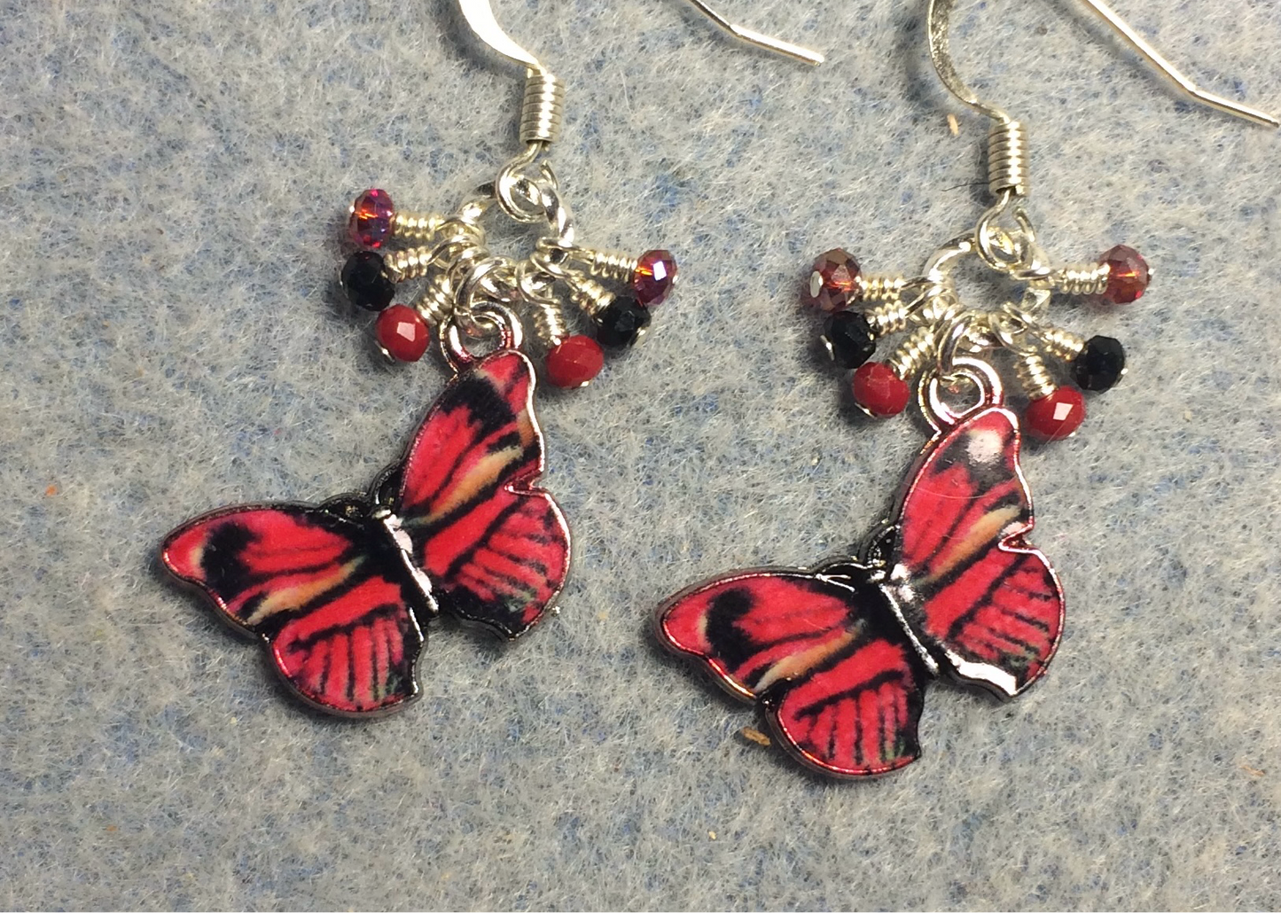 Red and black enamel butterfly charm earrings adorned with tiny dangling red and black Chinese crystal beads.