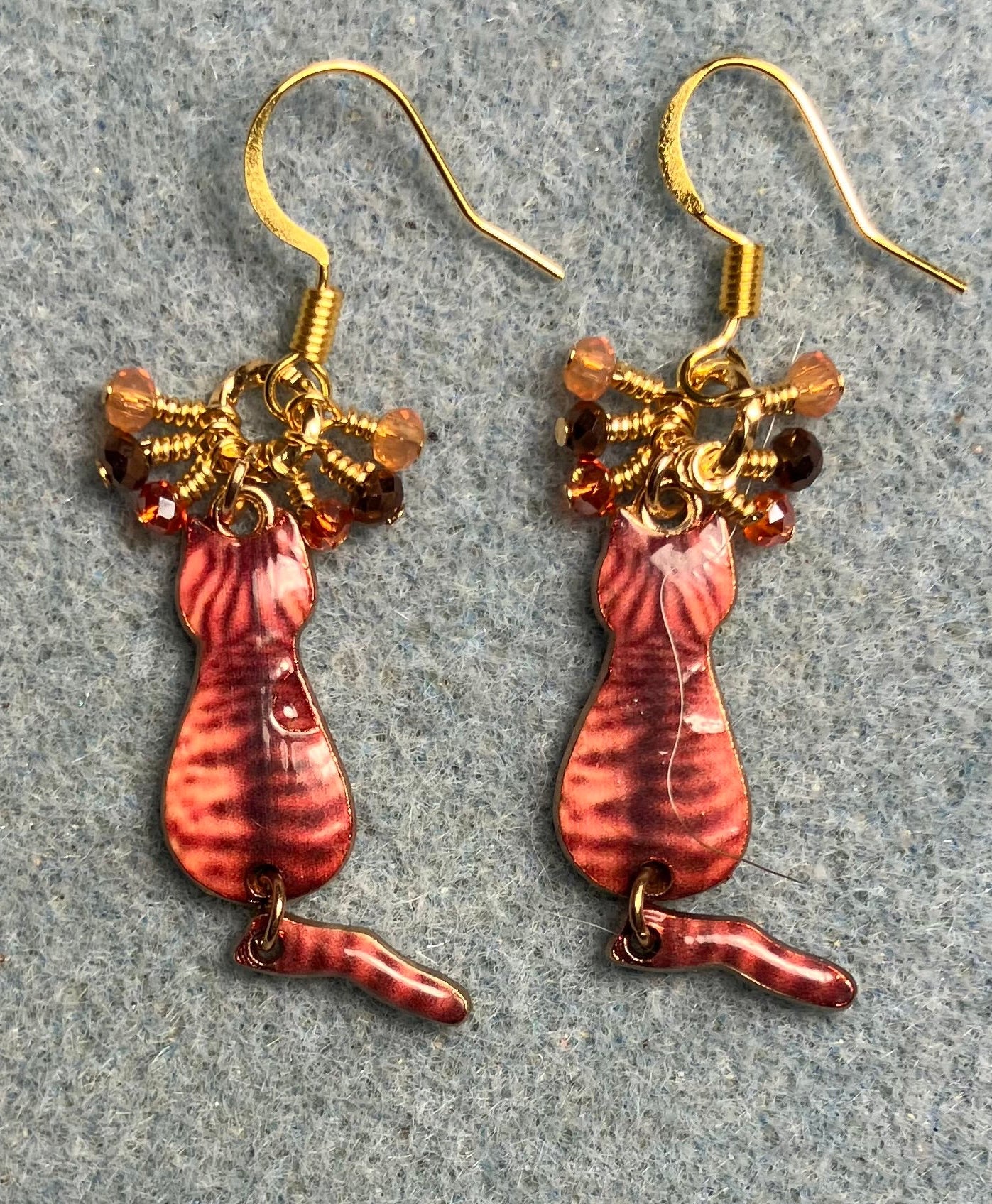 Orange and brown enamel tabby cat charm earrings adorned with tiny dangling orange and brown Chinese crystal beads.