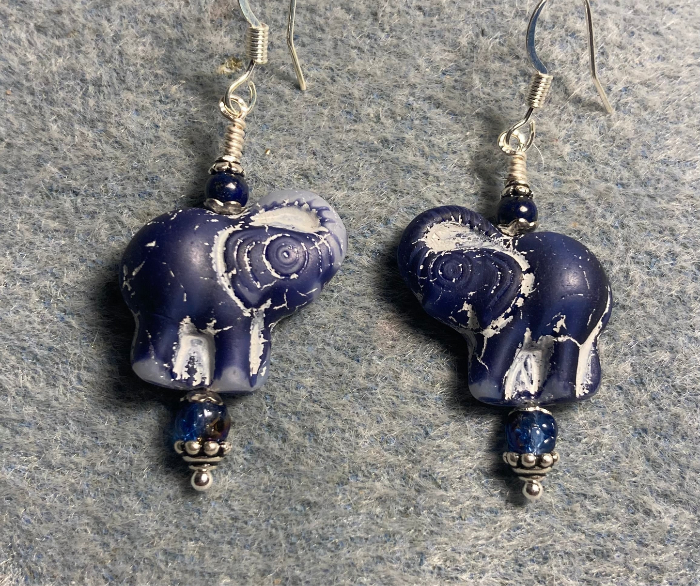 Opaque navy blue (with white inlay) Czech glass elephant bead earrings adorned with navy blue Czech glass beads.