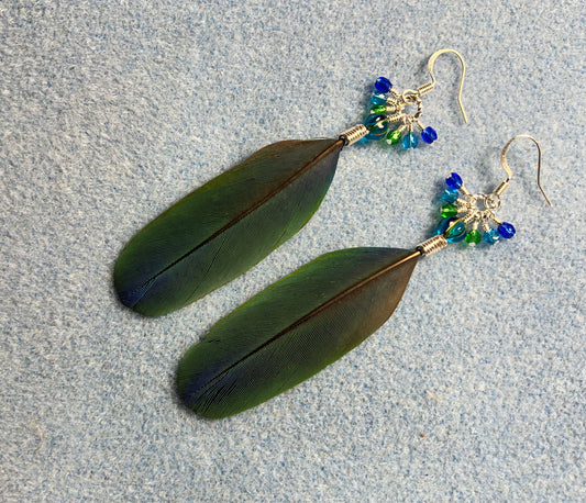 Blue and green white-fronted Pionus feather earrings adorned with blue green beads and tiny dangling blue and green Chinese crystal beads.