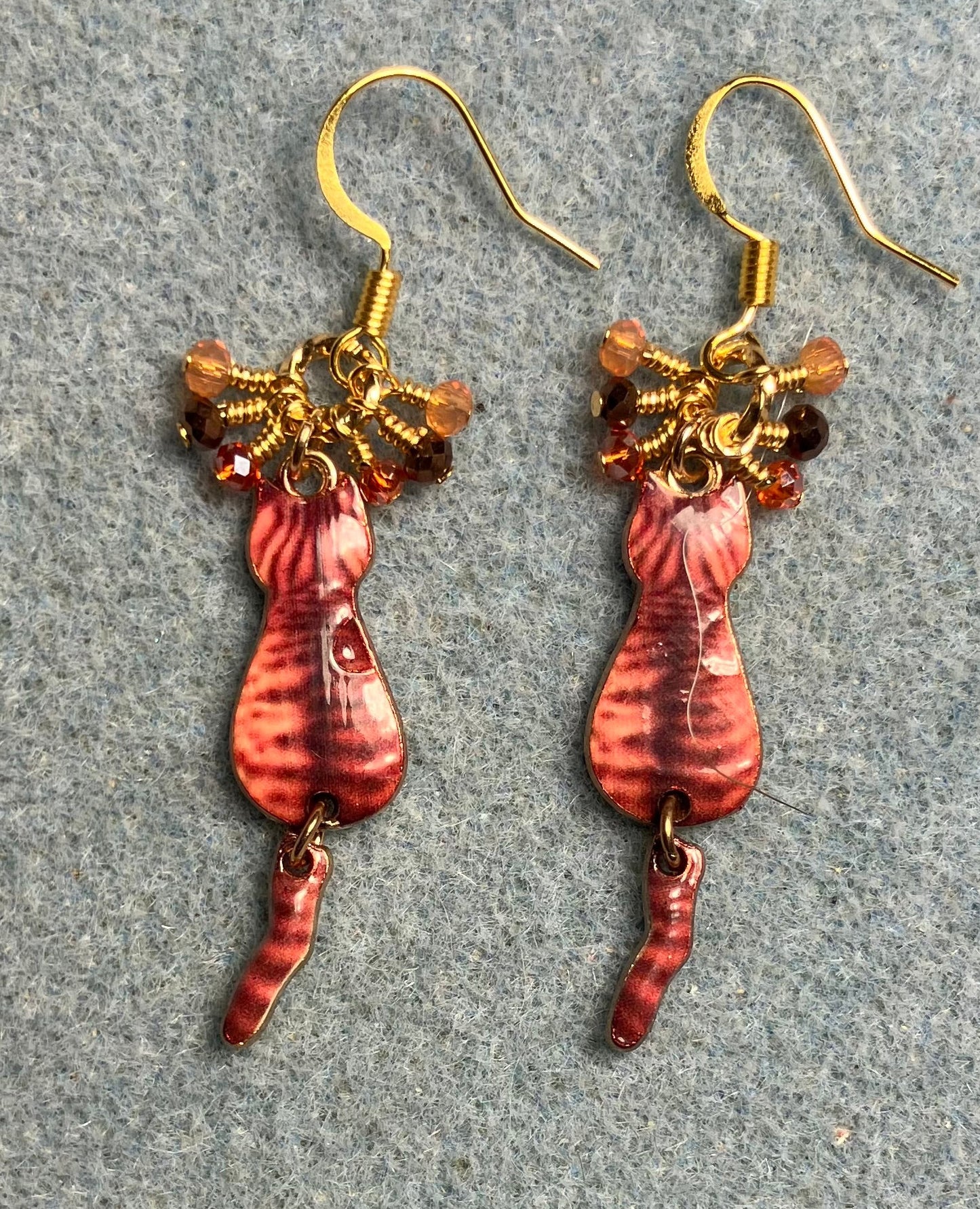 Orange and brown enamel tabby cat charm earrings adorned with tiny dangling orange and brown Chinese crystal beads.