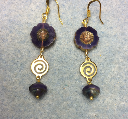 Opaque dark purple Czech glass pansy bead earrings adorned with gold swirly connectors and dark purple Czech glass Saturn beads.