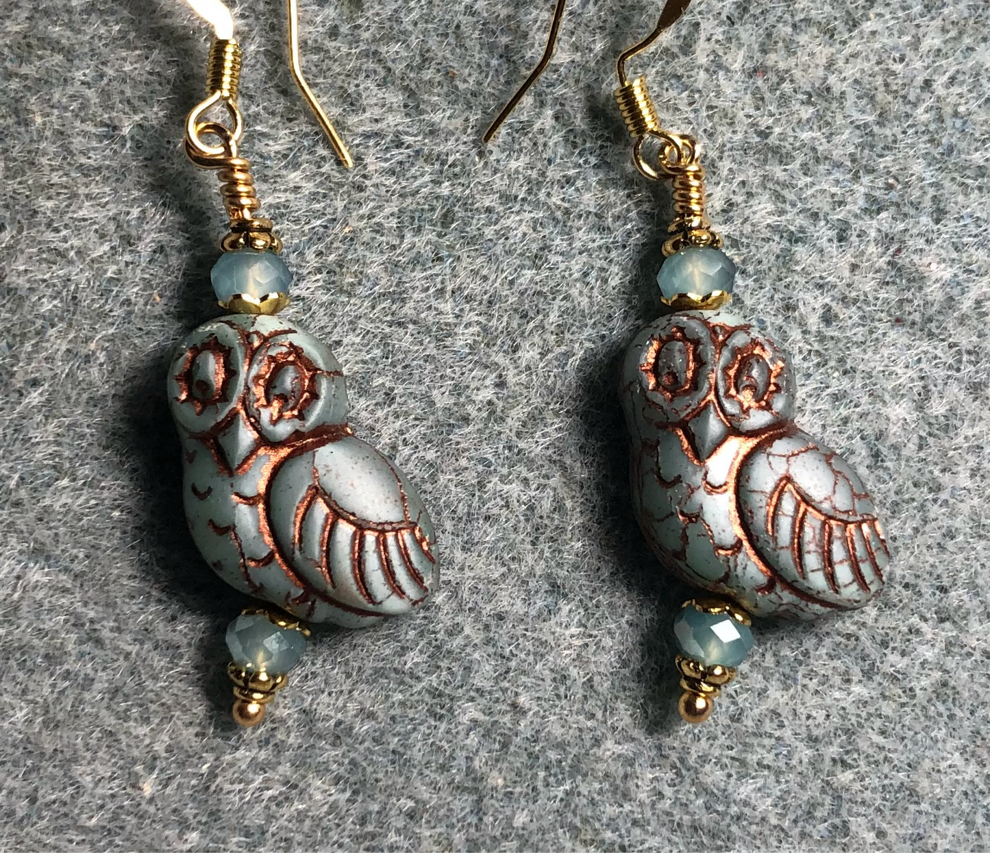 Light blue (with copper wash) fancy Czech glass owl bead earrings adorned with light blue Chinese crystal beads.