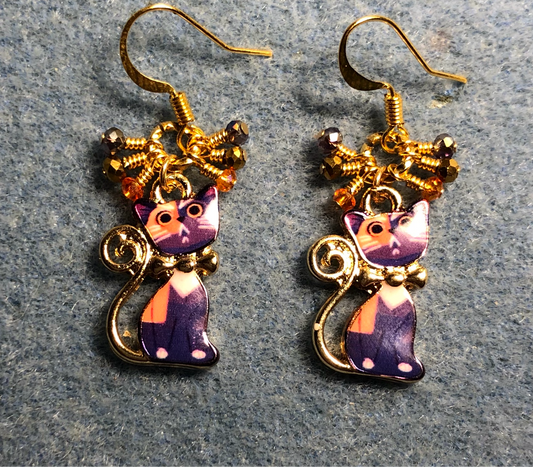 Purple, orange, and gold enamel cat charm earrings adorned with small dangling purple, orange, and gold Chinese crystal beads.