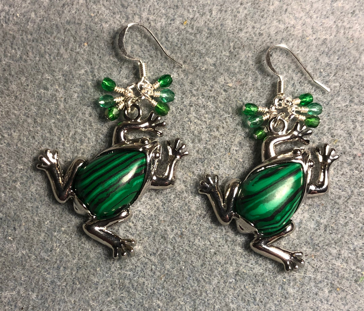 Large silver and green malachite gemstone frog charm earrings adorned with small dangling green Czech glass beads.