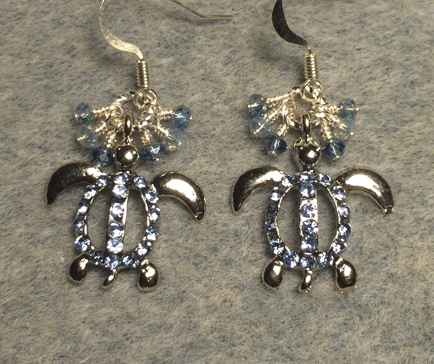 Silver with light blue rhinestone turtle charm earrings adorned with tiny dangling light blue Chinese crystal beads.