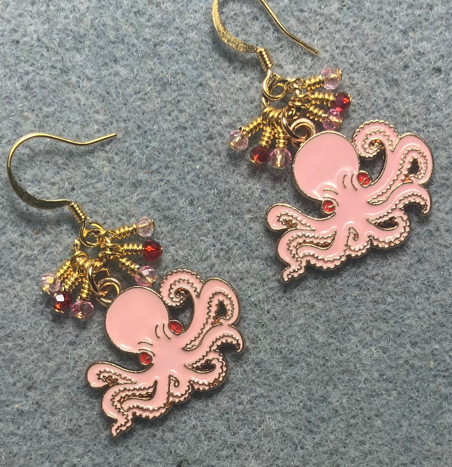 Pink, red, and gold enamel octopus charm earrings adorned with tiny dangling pink and red Chinese crystal beads.