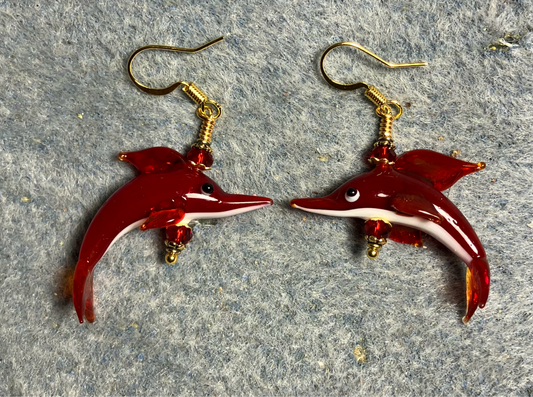 Dark red and white lamp work dolphin bead earrings adorned with dark red Chinese crystal beads.