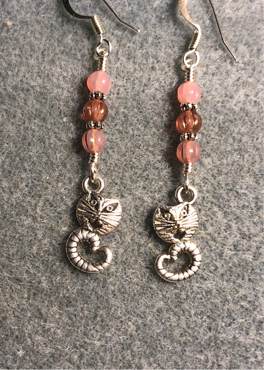 Silver Cheshire cat charm earrings adorned with milky pink Czech glass beads.
